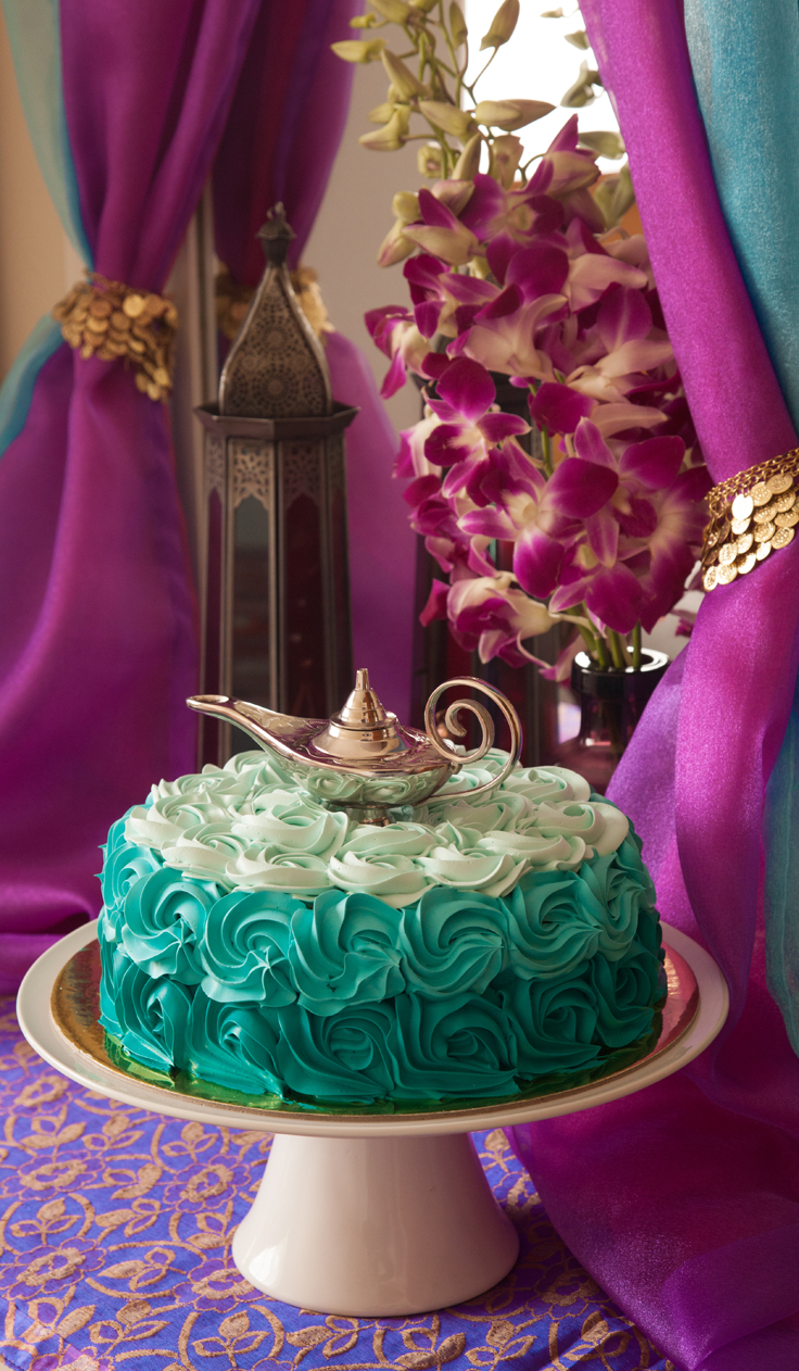 A Princess Jasmine-inspired teal cake topped with Aladdin's Lamp - perfect for an Arabian Nights theme party